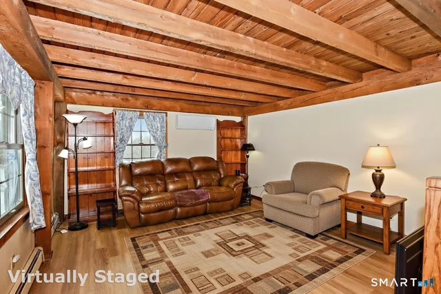 a bedroom with a bed next to a window