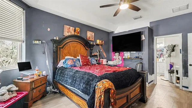 a bedroom with a bed and a flat screen tv