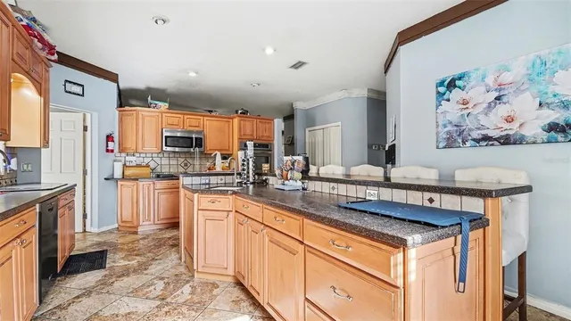 a kitchen with stainless steel appliances a sink stove and cabinets