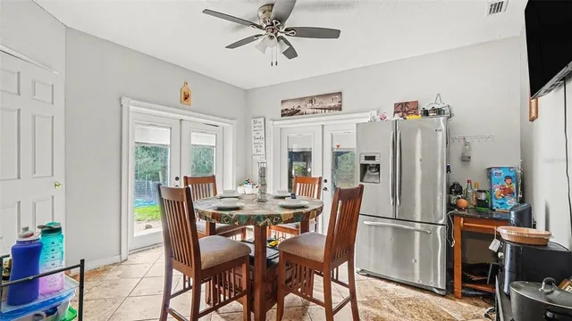 a view of a dining room with furniture and a chandelier