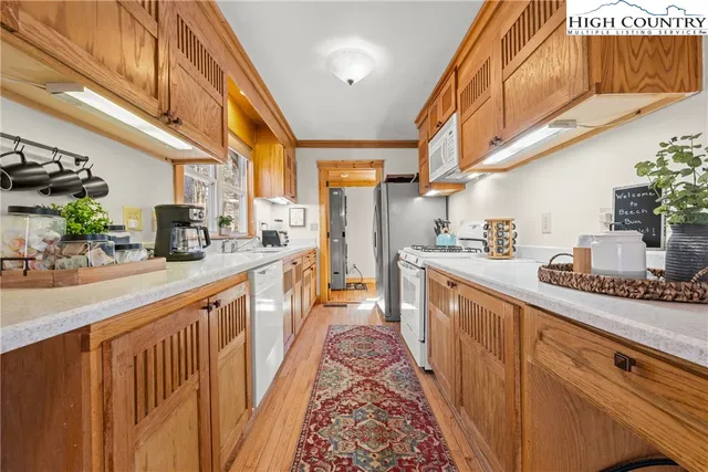 a kitchen with stainless steel appliances a sink and cabinets