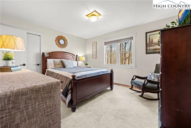 a bed room with a bed and a chair