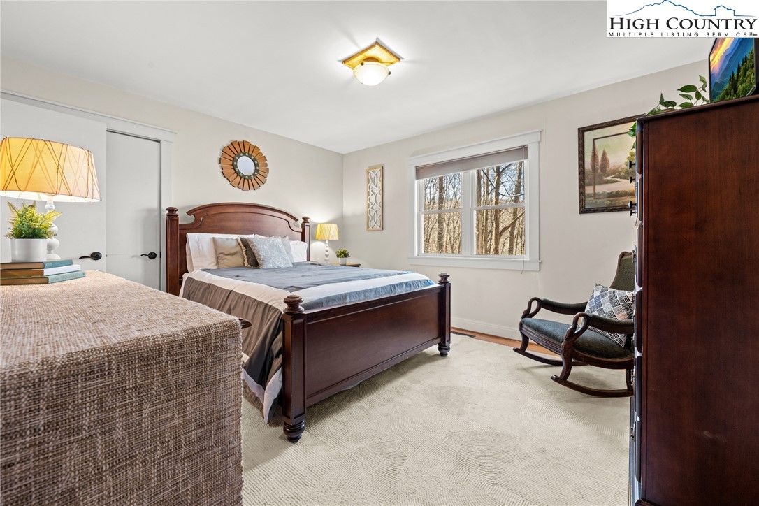 169 Hornbeam Road Beech Mountain, NC 28604 - Photo 17 of 48 a bed room with a bed and a chair