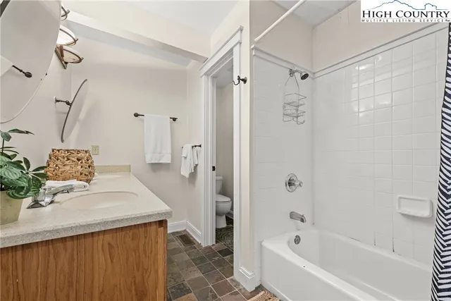 a bathroom with a bathtub and shower