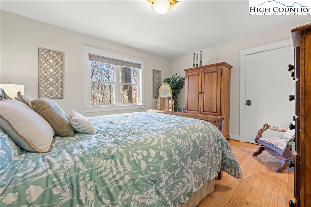 169 Hornbeam Road Beech Mountain, NC 28604 - Photo 21 of 48 a bedroom with a bed and a cabinets