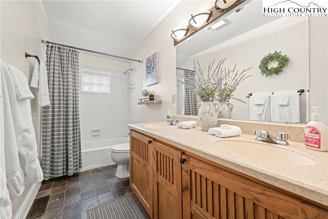 169 Hornbeam Road Beech Mountain, NC 28604 - Photo 22 of 48 a bathroom with a sink a toilet and shower