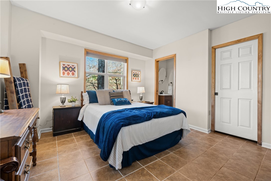 169 Hornbeam Road Beech Mountain, NC 28604 - Photo 33 of 48 a bed sitting in a bedroom next to a window