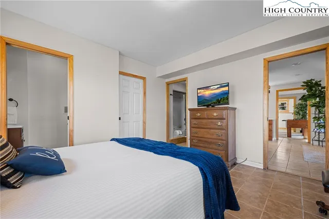 a bedroom with a bed and a television