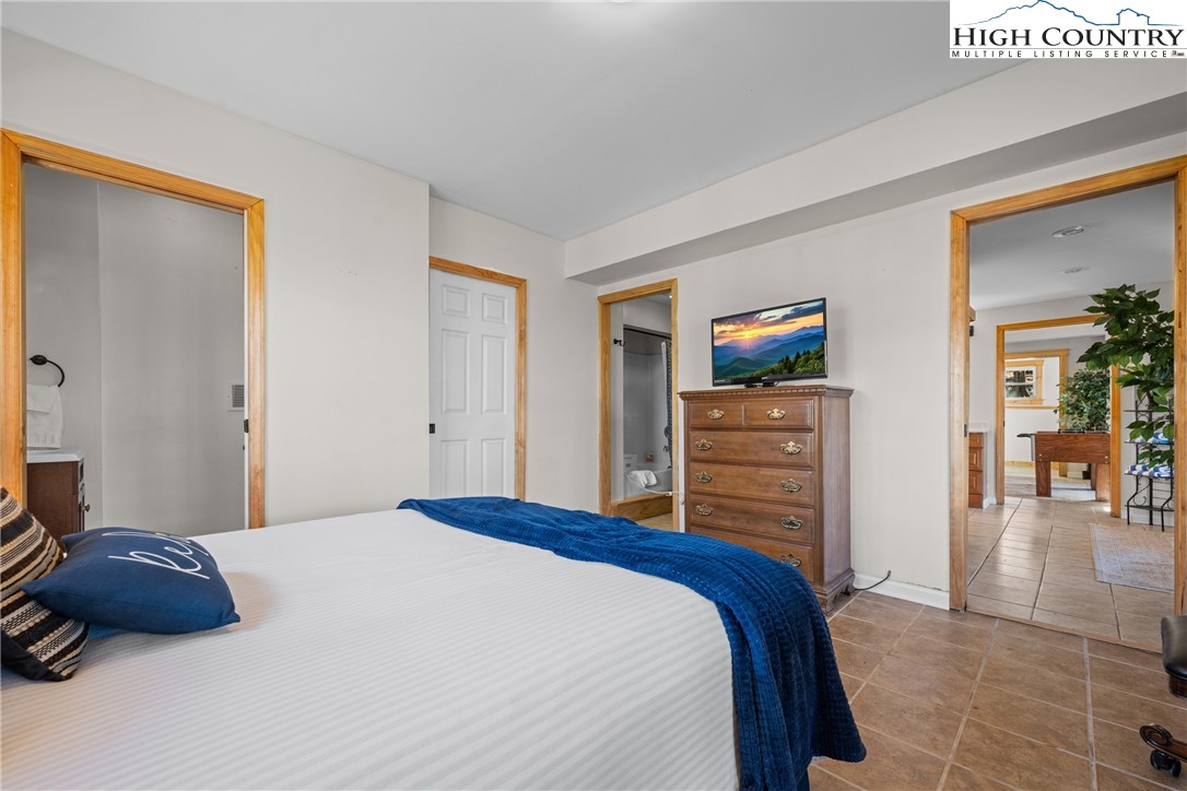 169 Hornbeam Road Beech Mountain, NC 28604 - Photo 34 of 48 a bedroom with a bed and a television