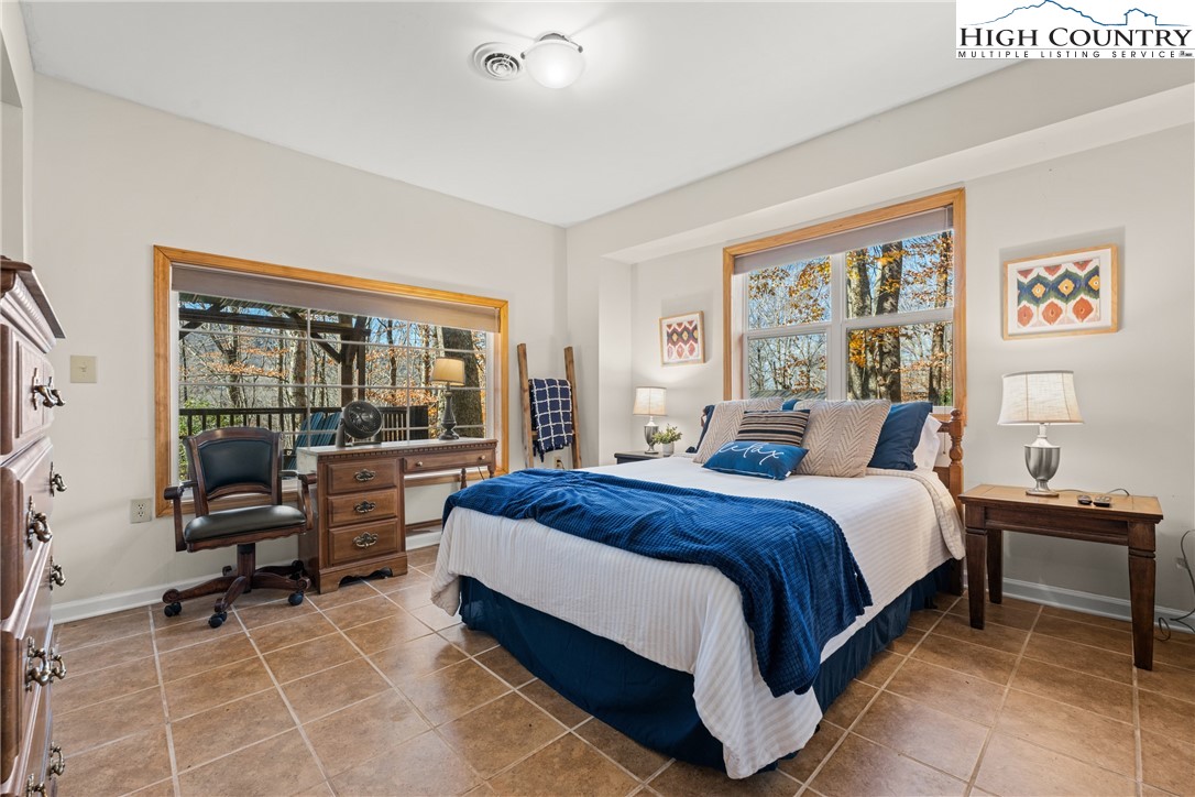 169 Hornbeam Road Beech Mountain, NC 28604 - Photo 35 of 48 a large bedroom with a bed and large window