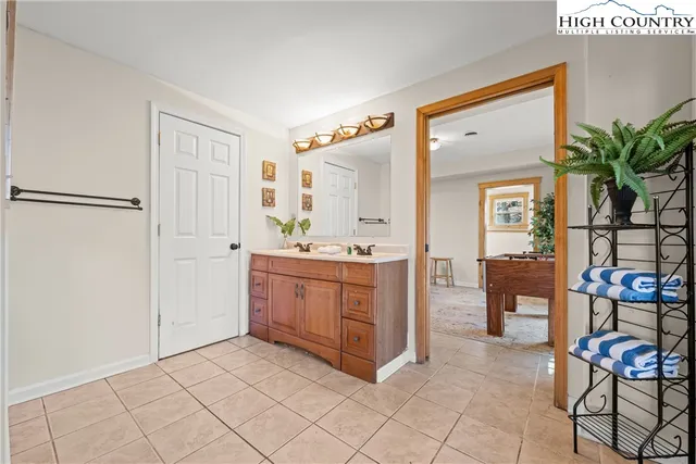 a bathroom with a sink a mirror and a shower