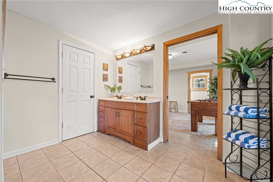 169 Hornbeam Road Beech Mountain, NC 28604 - Photo 36 of 48 a bathroom with a sink a mirror and a shower