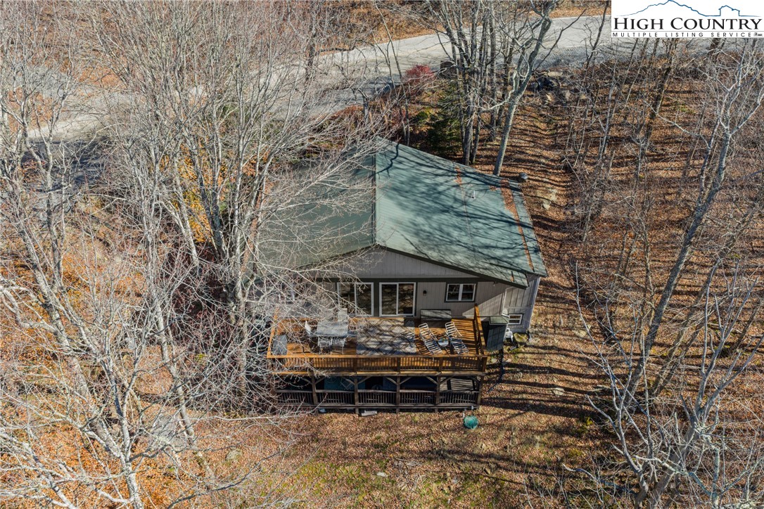 169 Hornbeam Road Beech Mountain, NC 28604 - Photo 46 of 48 a roof deck with table and chairs under an umbrella