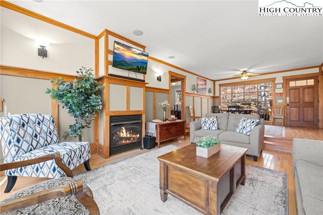 169 Hornbeam Road Beech Mountain, NC 28604 - Photo 8 of 48 a living room with furniture a fireplace and a large window