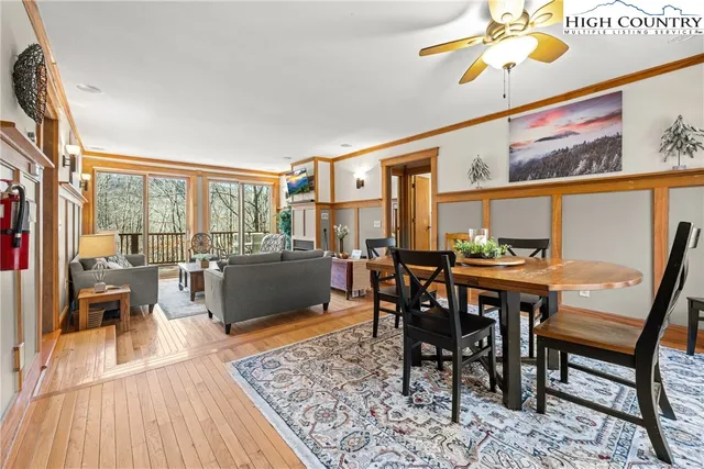 a dining room with furniture a rug and wooden floor