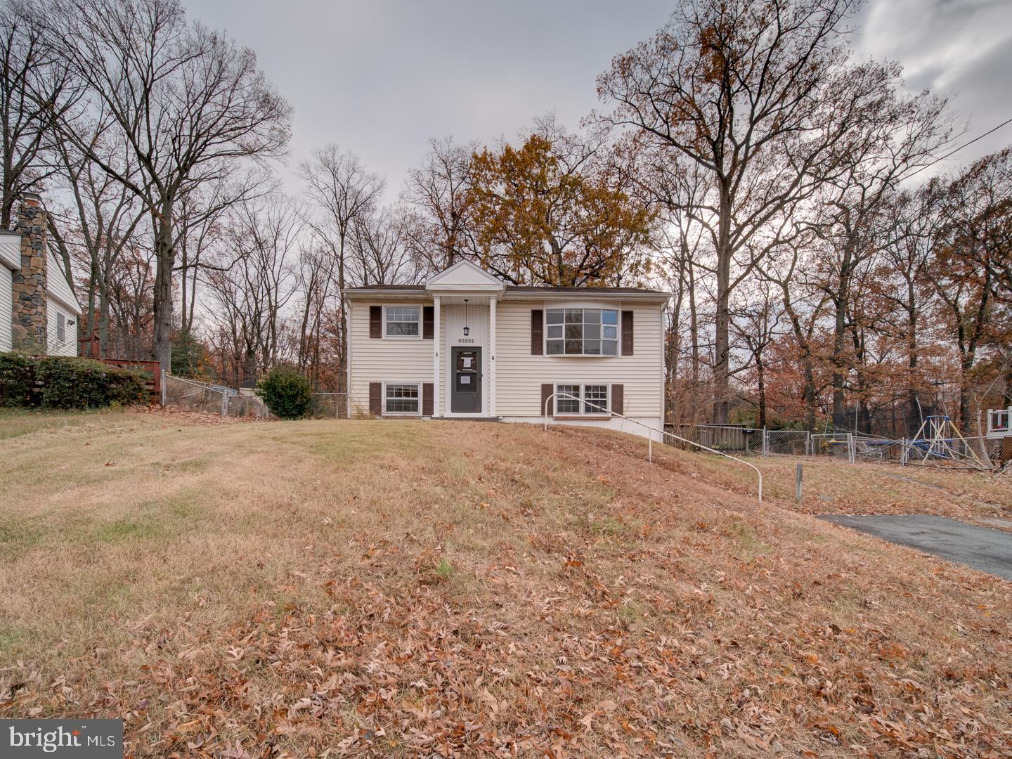 a view of a house with a yard covered in snow