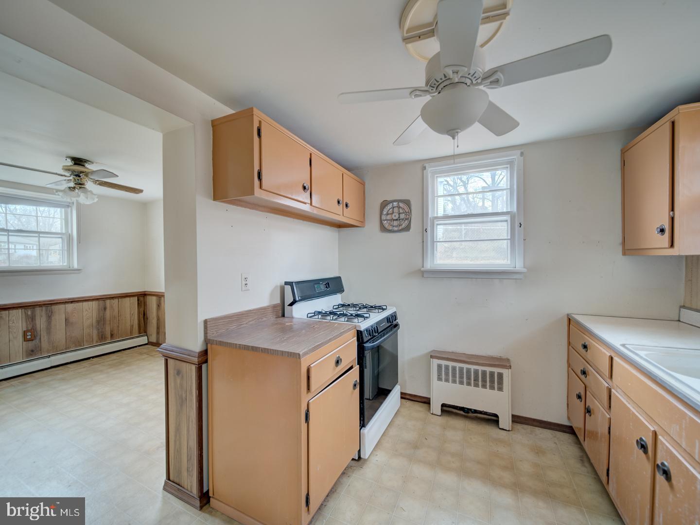 15140 Georgia Road Woodbridge, VA 22191 - Photo 26 of 37 a utility room with stainless steel appliances a stove a sink and a refrigerator