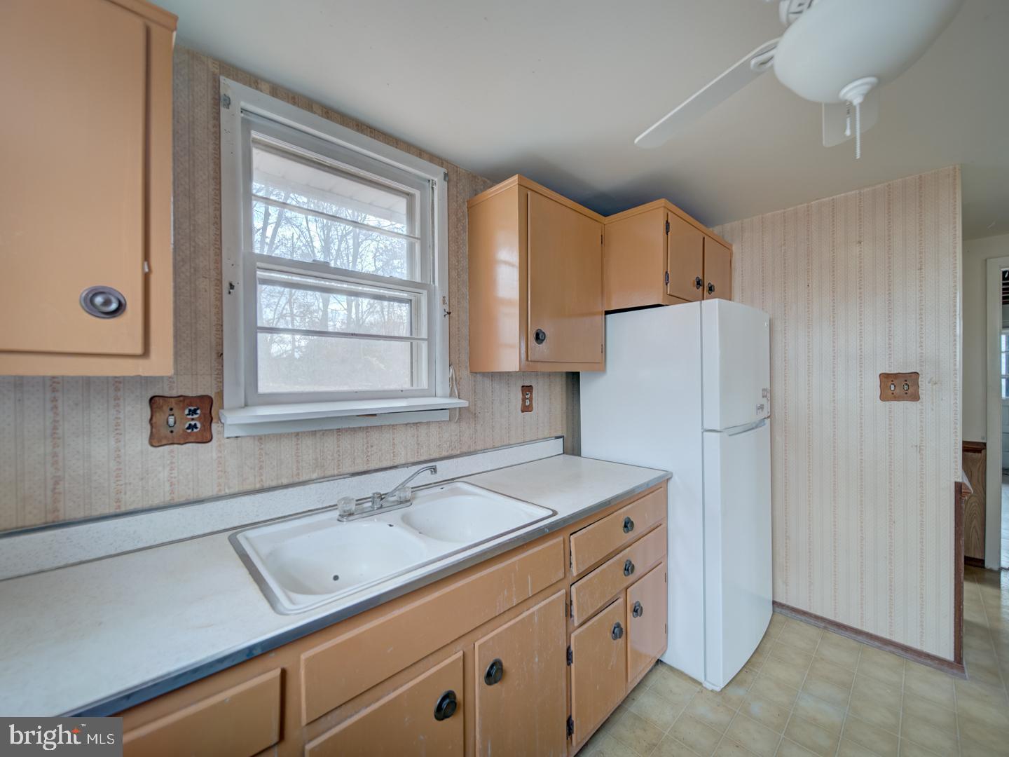 15140 Georgia Road Woodbridge, VA 22191 - Photo 27 of 37 a kitchen with cabinets appliances a sink and a window