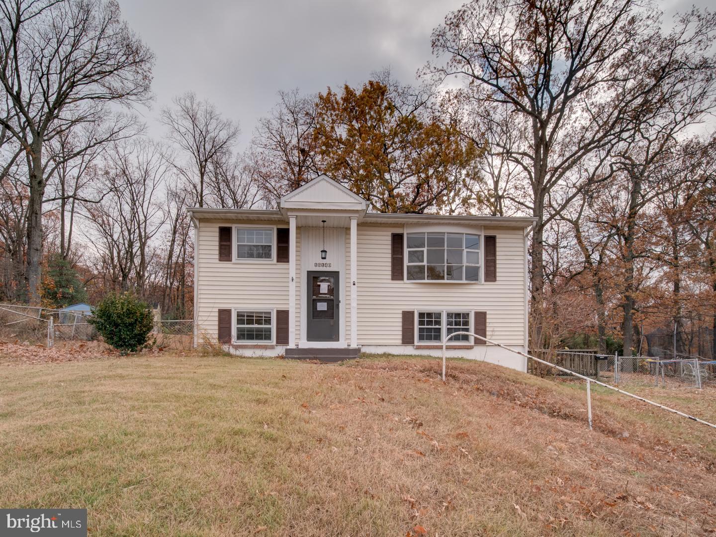 15140 Georgia Road Woodbridge, VA 22191 - Photo 3 of 37 a front view of a house with a large tree