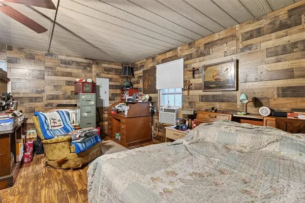 a bedroom with bed and a window