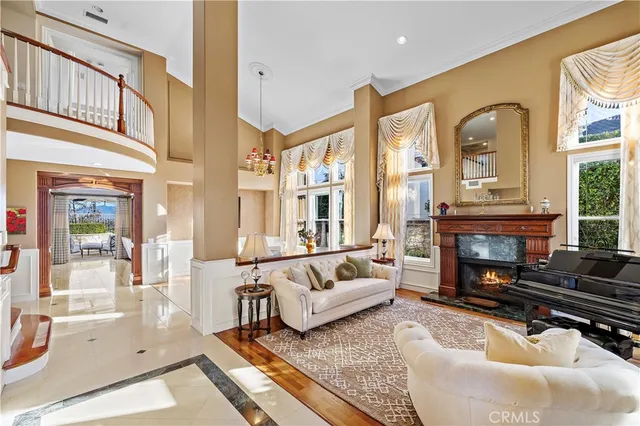 a living room with furniture a fireplace and a large window