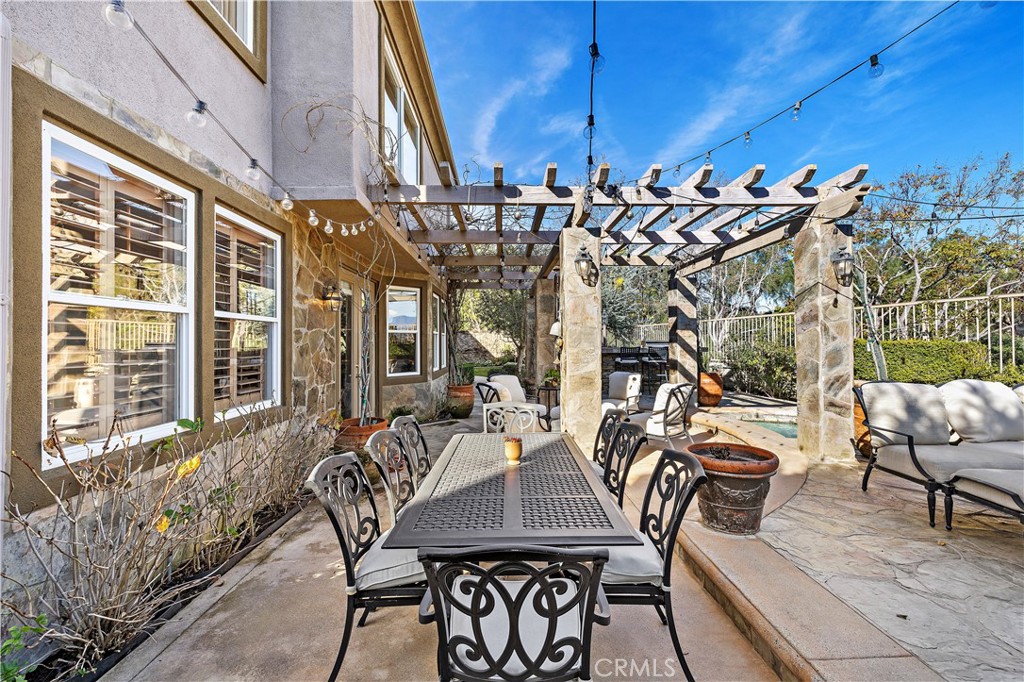 18 Asilomar Road Laguna Niguel, CA 92677 - Photo 6 of 46 Outdoor Dining Space with Wisteria covered arbor