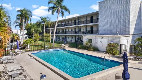 a view of swimming pool with a lounge chairs