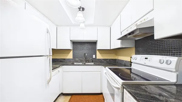 a kitchen with a sink a stove and refrigerator