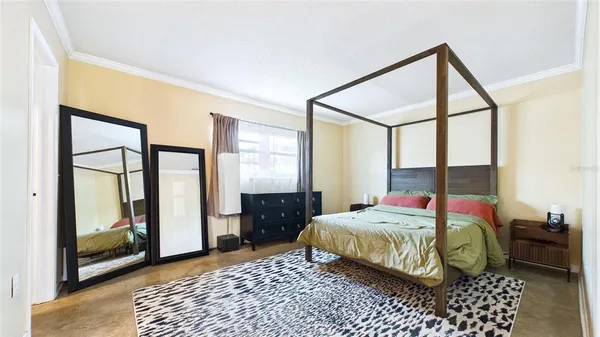a bedroom with a bed and a mirror