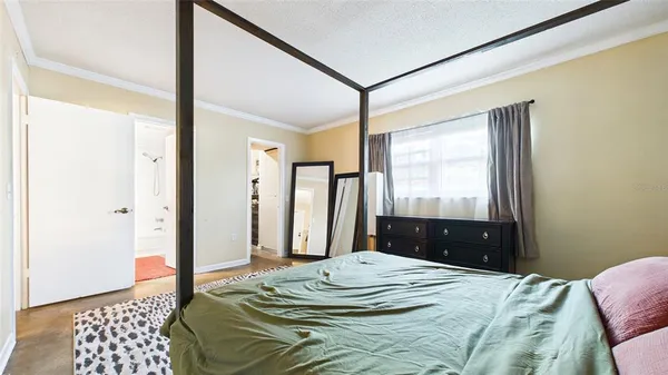 a bedroom with a bed and a dresser