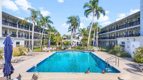 a view of a swimming pool with an outdoor seating