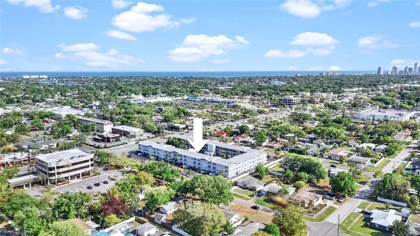 an aerial view of residential houses with city view
