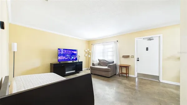 a living room with furniture and a flat screen tv