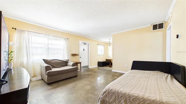 a bedroom with a bed and a couch