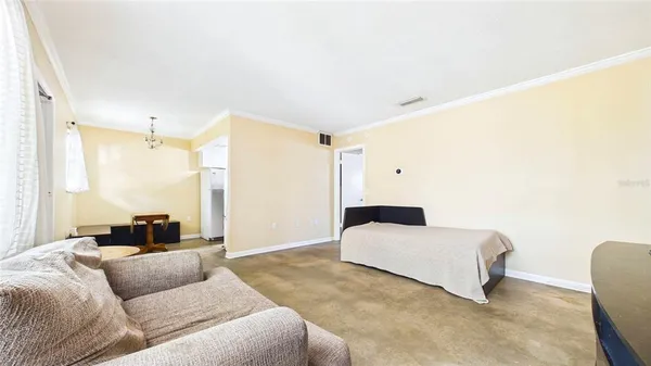 a bedroom with a bed and a couch