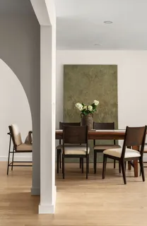 a view of a workspace room with wooden floor and furniture