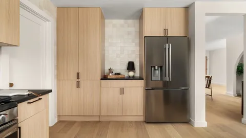 a kitchen with a refrigerator stove and cabinets