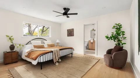 a bedroom with a bed and a potted plant