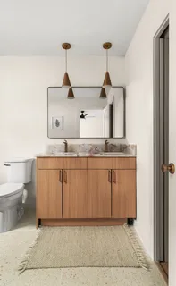 a bathroom with a toilet a sink and mirror