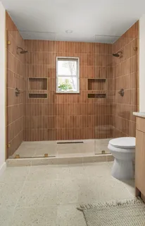a bathroom with a toilet and shower
