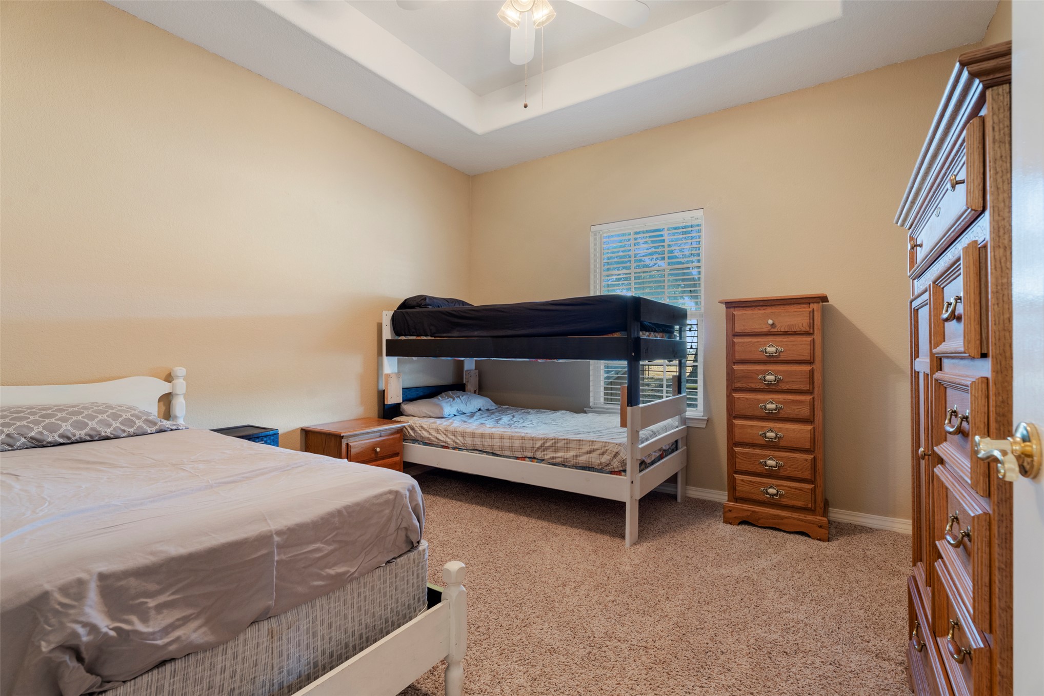 20233 East 570 Road Colcord, OK 74338 - Photo 23 of 39 Tray ceiling with ceiling fan, carpet flooring, and a window with blinds