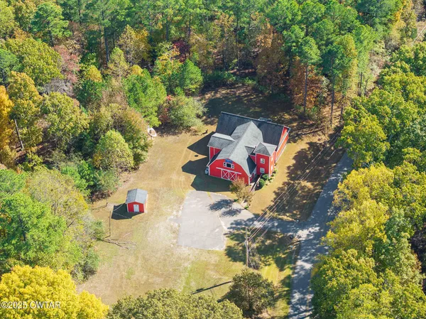 an aerial view of a houses with a yard