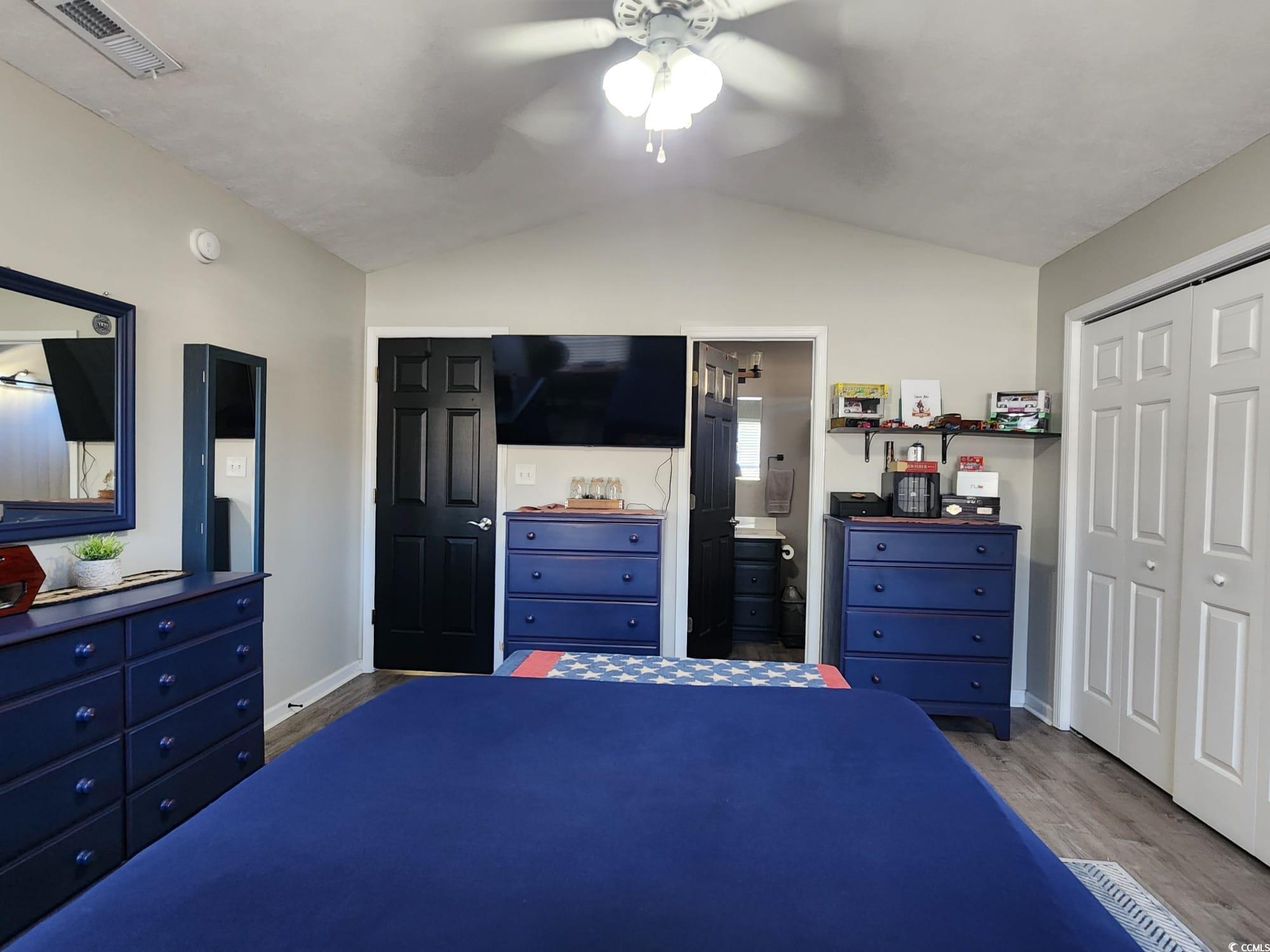 9883 Conifer Lane Murrells Inlet, SC 29576 - Photo 11 of 24 Bedroom with wood finished floors, visible vents,