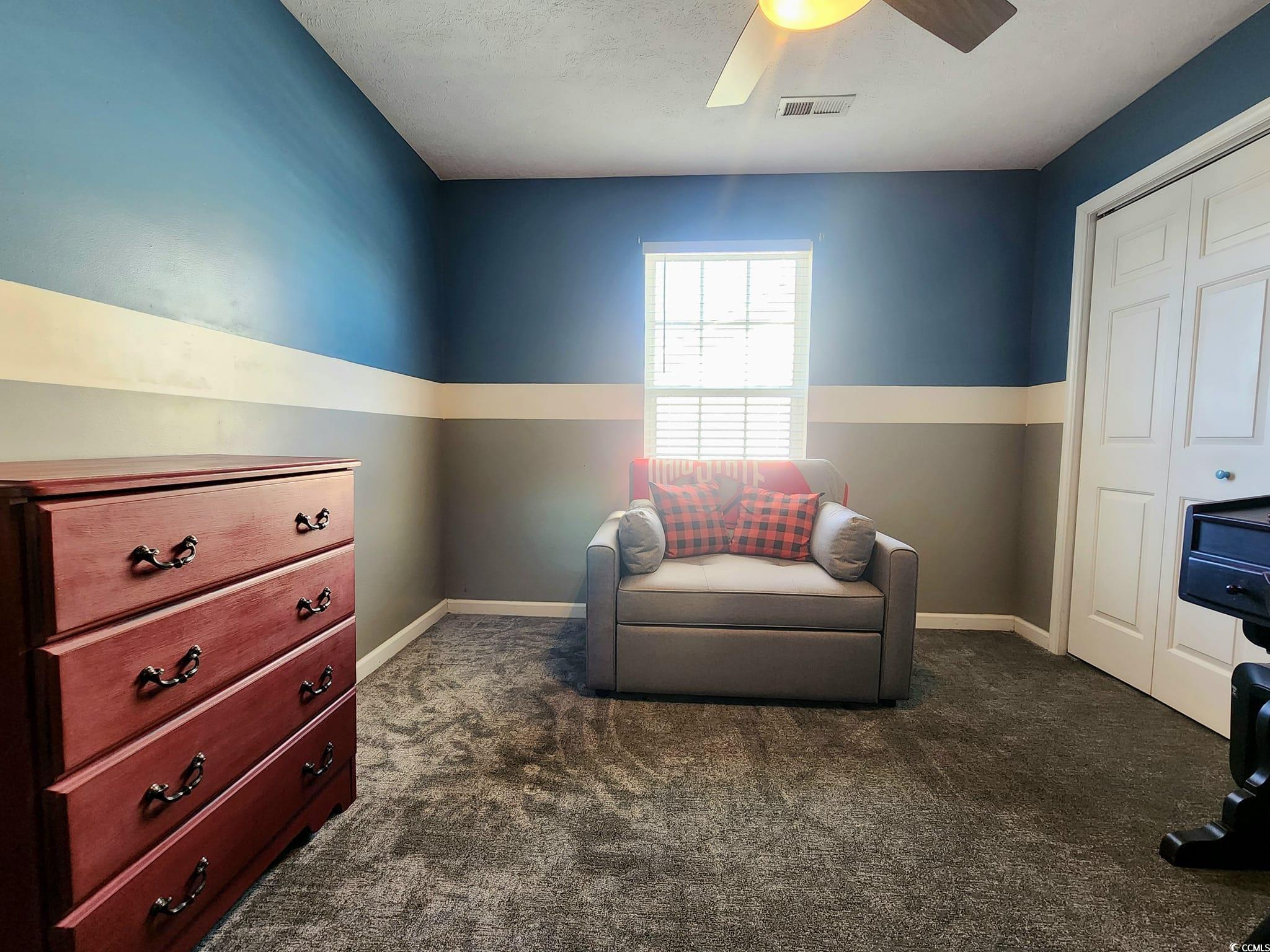 9883 Conifer Lane Murrells Inlet, SC 29576 - Photo 16 of 24 Living area with a ceiling fan, visible vents, dar