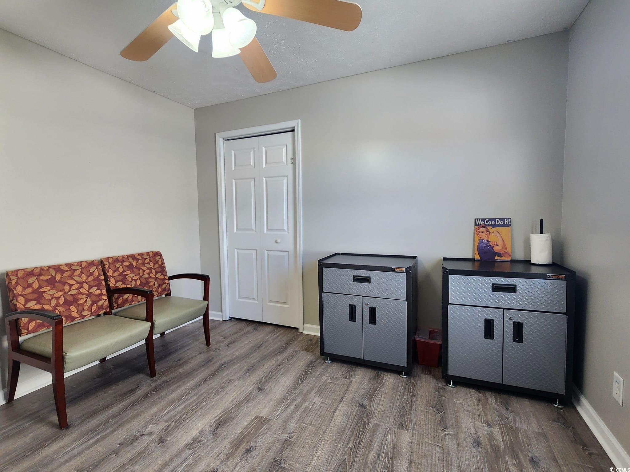 9883 Conifer Lane Murrells Inlet, SC 29576 - Photo 19 of 24 Living area with baseboards, wood finished floors,