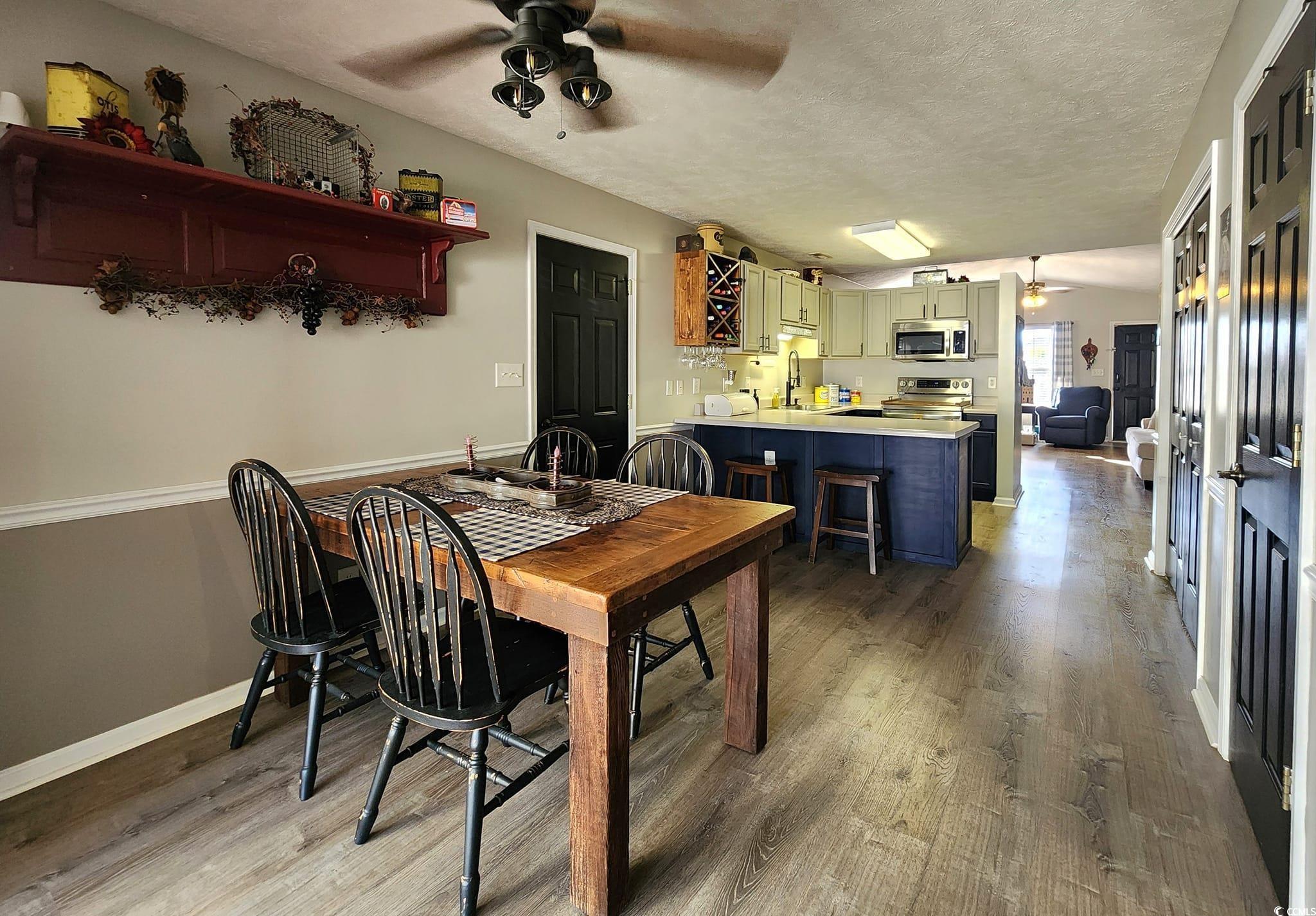 9883 Conifer Lane Murrells Inlet, SC 29576 - Photo 9 of 24 Dining space featuring a textured ceiling, light w