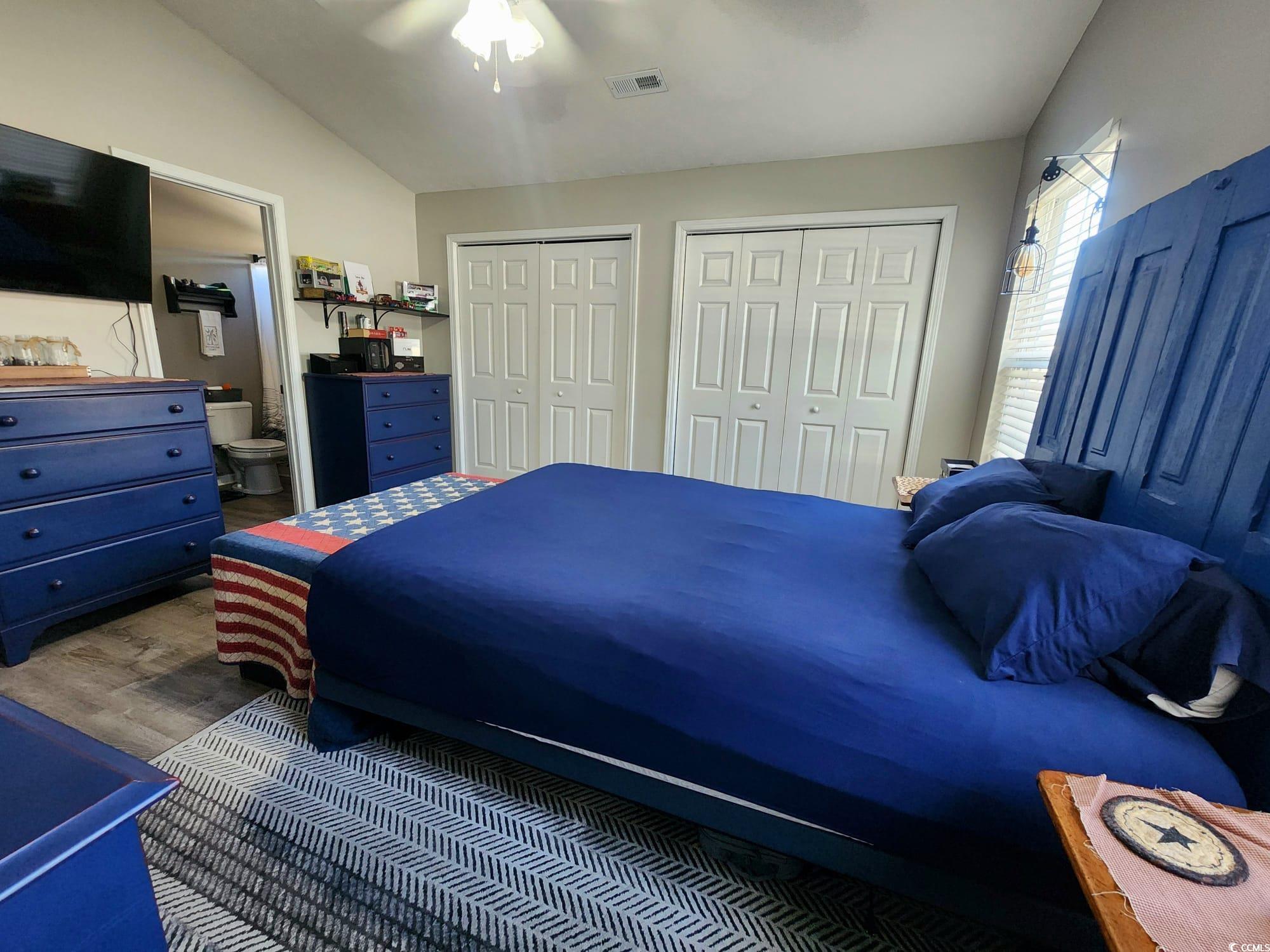 9883 Conifer Lane Murrells Inlet, SC 29576 - Photo 10 of 24 Bedroom with visible vents, multiple closets, wood