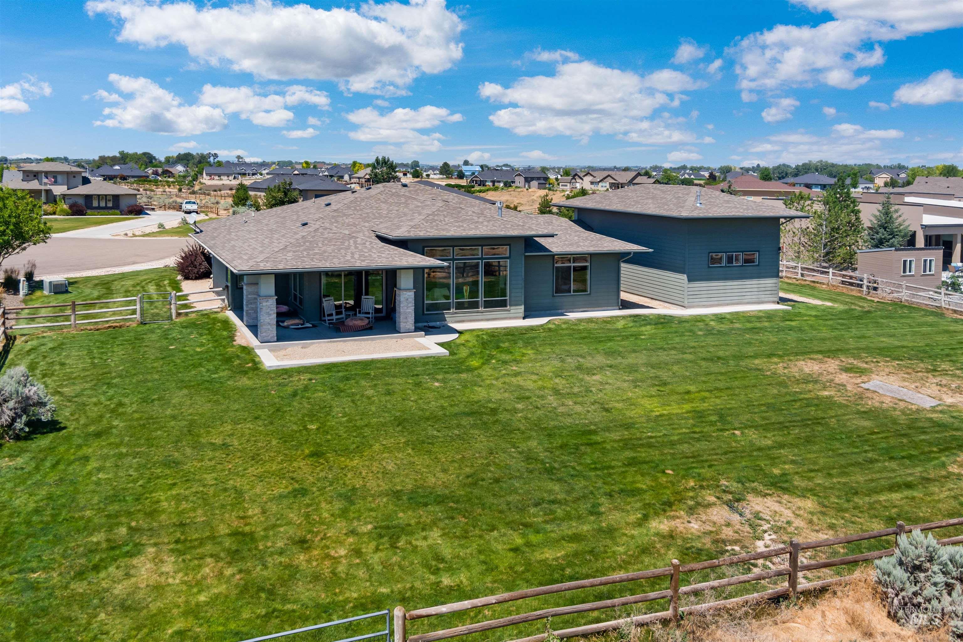 24398 Tombstone Ridge Court Middleton, ID 83644 - Photo 37 of 47 Expansive rear yard featuring a large patio space, mature landscaping, and a substantial detached structure