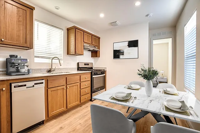 a kitchen with stainless steel appliances kitchen island granite countertop a sink and cabinets