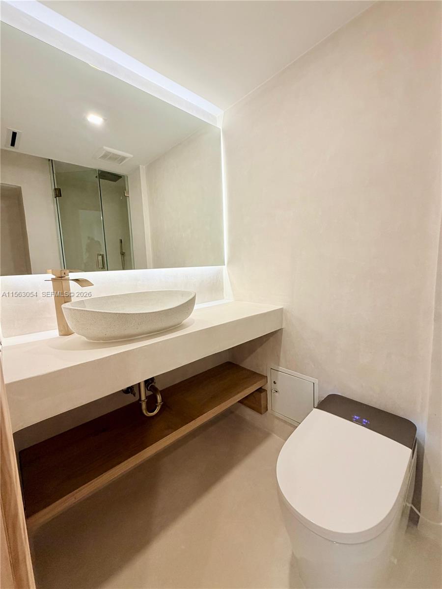 100 Lincoln Road, Unit 1241 Miami Beach, FL 33139 - Photo 9 of 18 a bathroom with a sink and a toilet